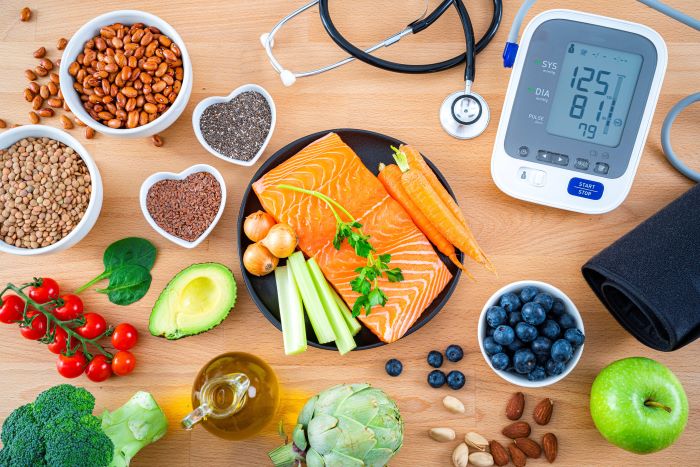 Healthy food on a table with a blood pressure monitor